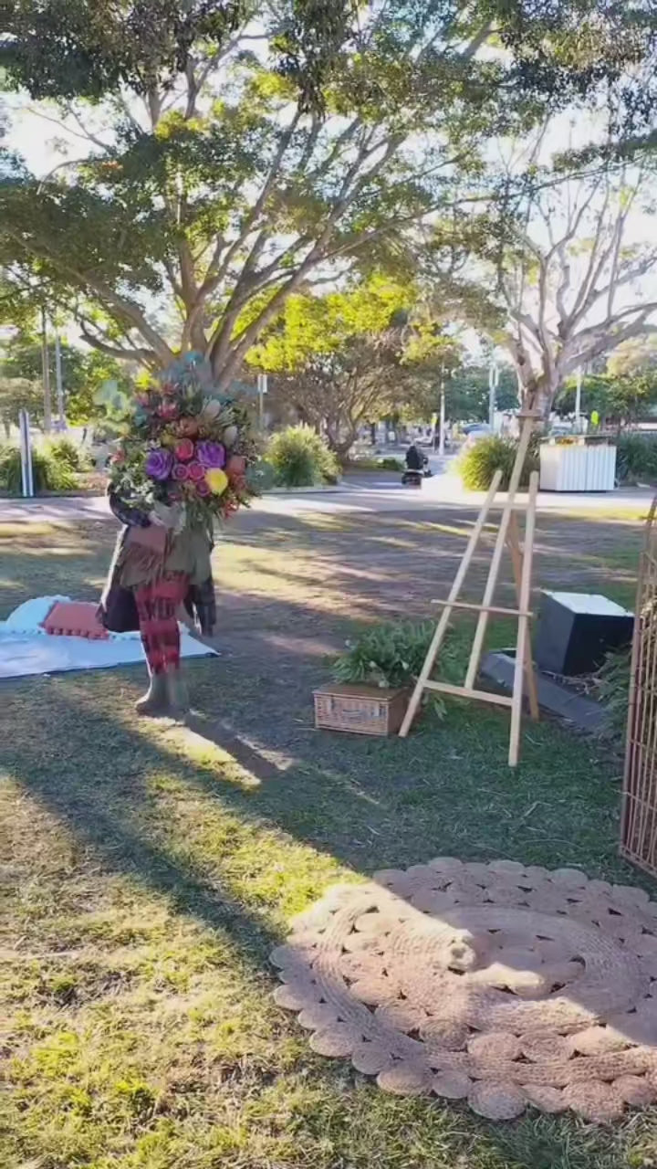Load video: A beautiful memorible outdoor funeral service, with stunning flower arrangements , Arbor spray and tall round frontal arrangement, something the whole family will hold in their hearts, set against the picturesque Bribie Island.